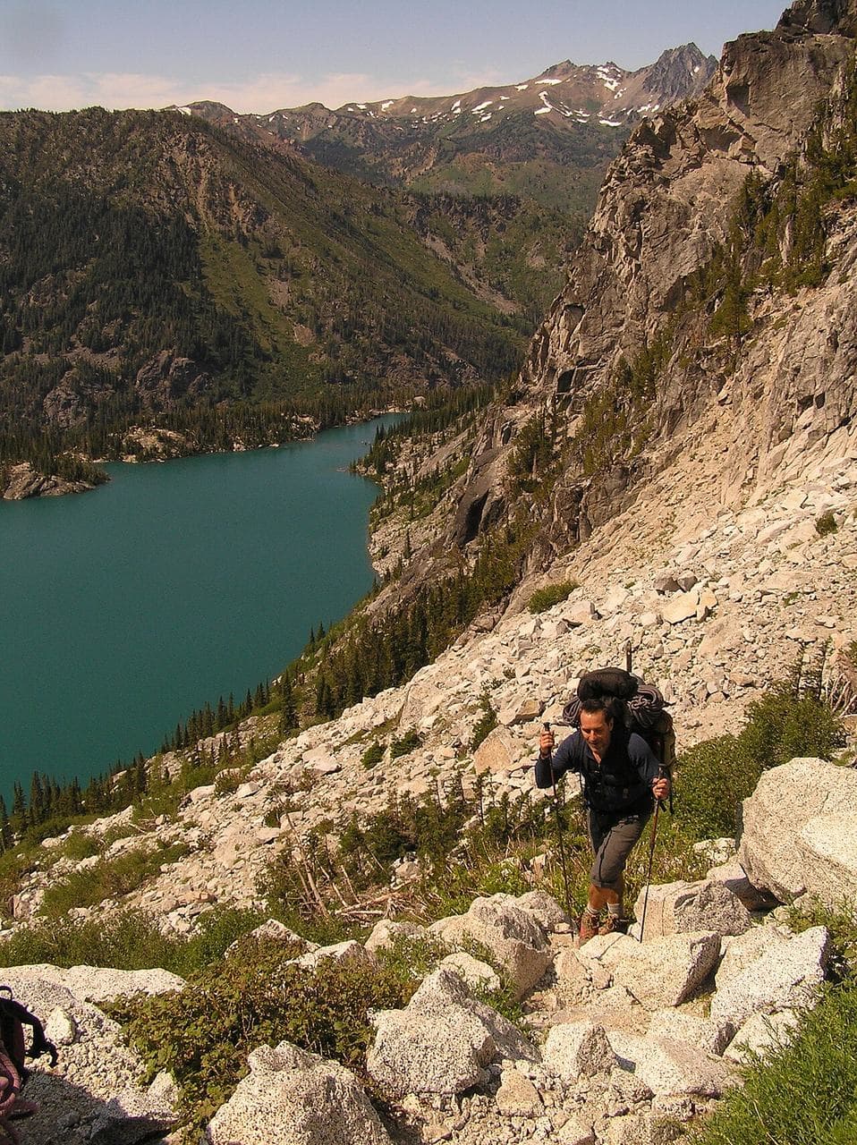 A hiker climbing Aasgard Pass high above Colchuck Lake