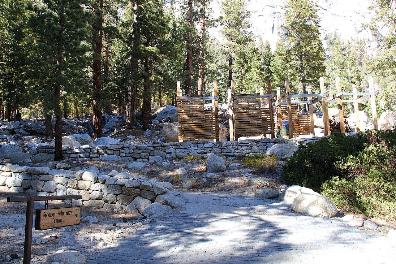 The Mount Whitney Trail sign and bear boxes at Whitney Portal