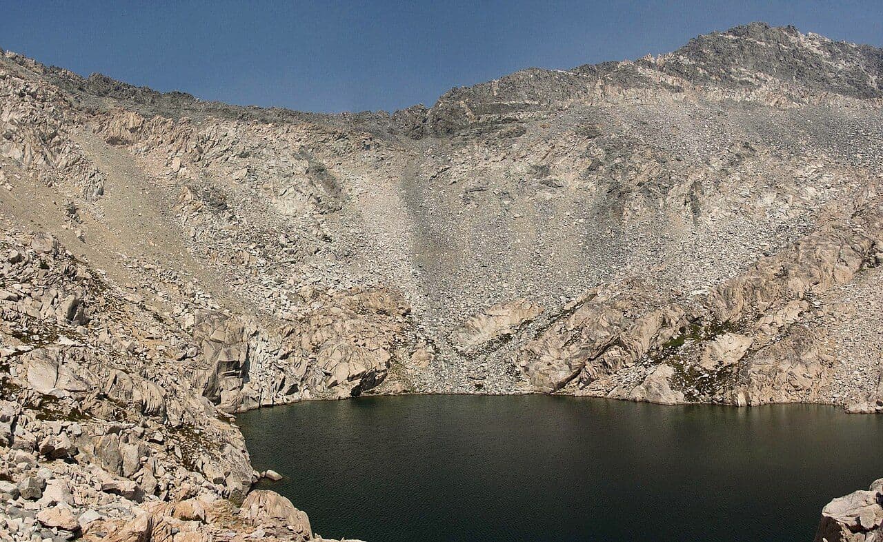 The headwall of Glen Pass above a dark tarn, seen from the south