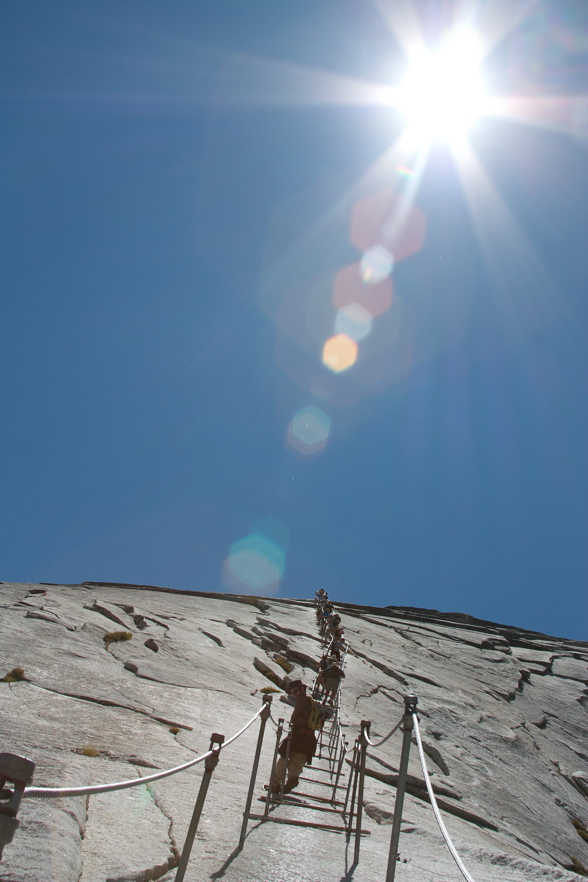 Hikers climbing the cables on Half Dome, Yosemite National Park